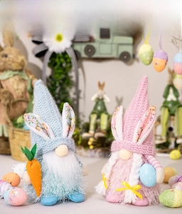 Detail of Easter gnomes with rabbit ears, holding carrot and polka dot egg decorations