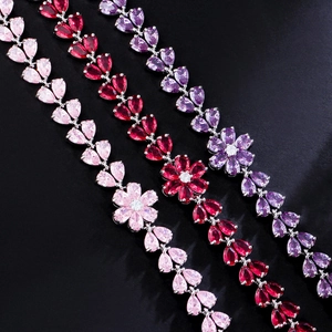 Detailed macro view of vibrant pear-cut zircon flower charms in pink, red, and purple colors