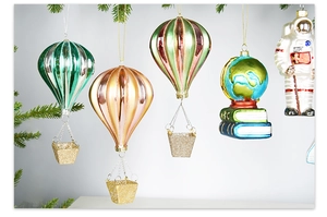 Detail of hand-painted Christmas ornaments including astronaut and globe on tree