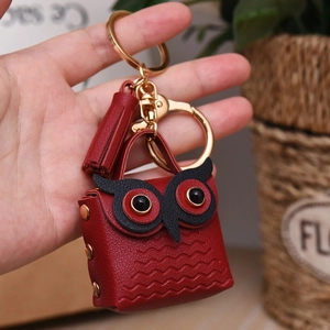 Red leather owl coin purse keychain with golden metal clasp and decorative tassel