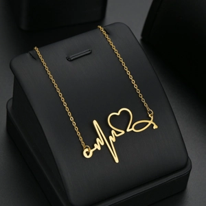 Fashionable heartbeat stethoscope gold necklace with heart pendant on black display