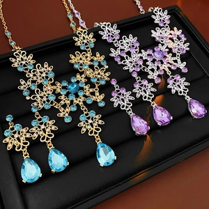 Close-up of vintage flower necklaces with water drop tassels in blue and purple