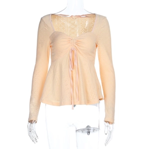 Detail of apricot lace long sleeve top with drawstring ruching and ruffle hem detail