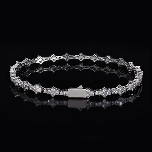 Luxury silver tennis bracelet with sparkling zircons on a black reflective mirror background