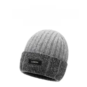 Close-up of grey ribbed knit beanie showing the black LA&DH logo tag and thick texture