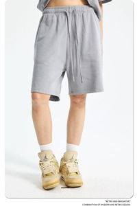 Macro shot of grey cotton knit shorts detailing adjustable drawstring and soft texture