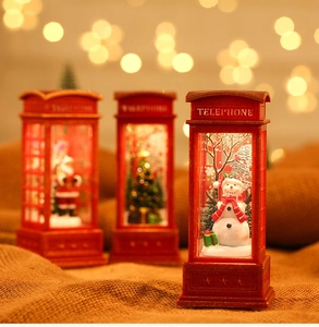 Close-up of red Christmas telephone booth lamp with snowman and Santa miniature scenes