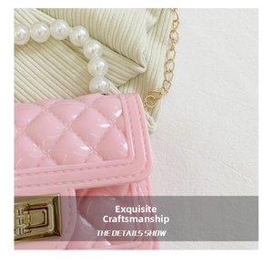 Detailed close-up of pink quilted jelly bag featuring pearl handle and gold chain strap