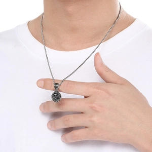 Male model wearing silver punk skull pendant necklace with rope chain on white tee