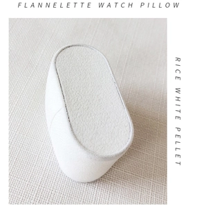 Macro detail of soft rice white flannelette watch pillow with premium pellet padding