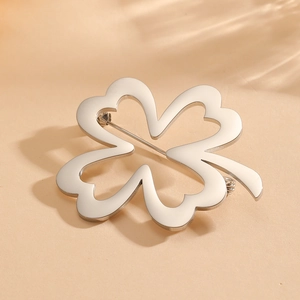 Modern silver hollowed four-leaf clover brooch pin made of vacuum plated titanium steel