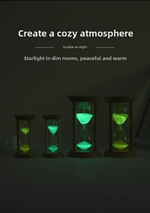 Glow-in-the-dark sand timers with minimalist wooden frames in green and gold lighting