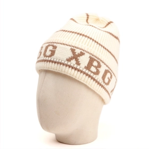 Detailed close-up of striped knit beanie with XBG lettering on high-quality fabric