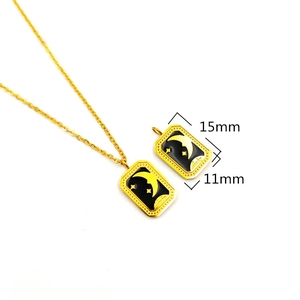Detail view of 18K gold plated steel pendant with stars and moon motif, 15mm by 11mm