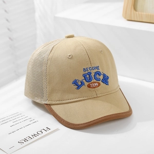 Detail of breathable mesh and high-quality Luck 1998 embroidery on a beige baby cap