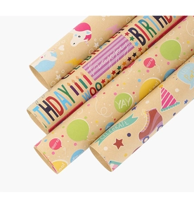 Detail of kraft paper gift wrap rolls featuring colorful birthday patterns and text