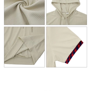 Detailed waffle texture and stylish red-blue plaid inner lining on sleeve cuffs of hooded polo