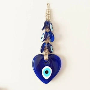Blue Evil Eye heart pendant with glass beads and braided rope on white background
