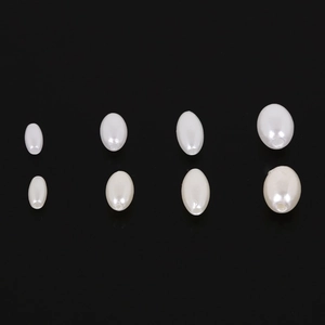 Detail of white oval ABS faux pearls in four sizes for DIY jewelry making and bracelets