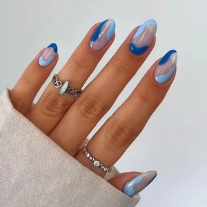 Blue sea salt ripple press-on nails with silver rings and opal stone on hand