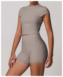 Detail view of high-waist yoga shorts and cropped short-sleeve shirt in Morandi gray