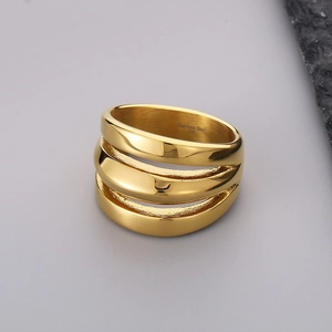 Detail of three-layered gold ring showing 316L stainless steel engraving and polished finish