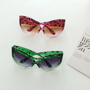 Oversized cat-eye sunglasses with heart cutout bridge and leopard print patterns