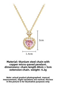 Macro detail of heart pendant necklace with pink gem and white zircon micro-inlay