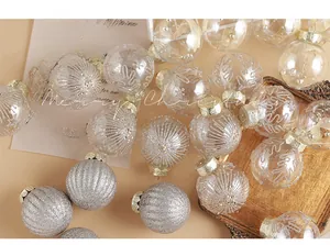 Detail of elegant champagne and white Christmas tree ornaments with elk motifs and glitter