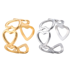 Detail of adjustable hollow heart rings in polished gold and silver stainless steel