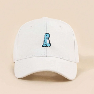 Close-up of a blue cartoon dinosaur embroidery on a white cotton baseball cap fabric