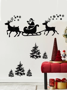 Stickers muraux noirs de Noël avec traîneau du Père Noël et rennes sur un mur blanc