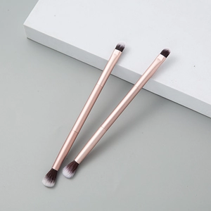 Set of two dual-ended rose gold makeup brushes for blending eyeshadow and nose contouring