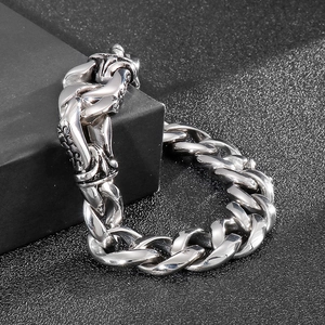 Detail shot of heavy silver stainless steel cuban chain bracelet on black display