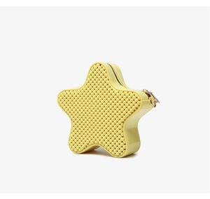Detail of yellow star-shaped PVC jelly bag with textured finish and gold zipper hardware