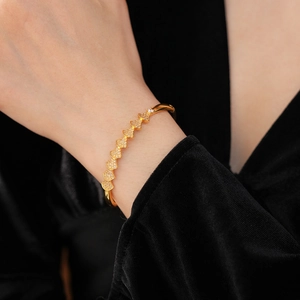 Close-up of gold-plated fan-shaped bracelet featuring micro-pave cubic zirconia on wrist