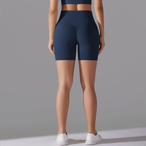 Detail view of the V-shaped back seam on high-waisted seamless navy blue yoga shorts