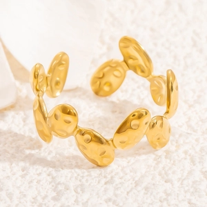 Detailed macro view of gold-plated stainless steel ring with hammered oval link texture