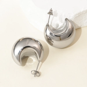 Polished silver stainless steel C-shaped half moon stud earrings on minimalist stones