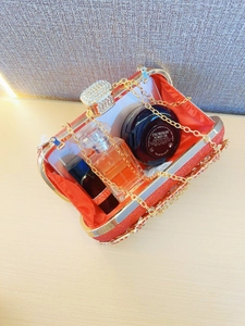 Sparkling red sequin evening clutch bag with gold chain and large crystal clasp decoration