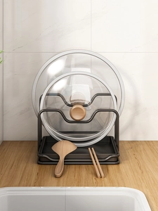 Dual-tier black metal pot lid rack with wood accents on a kitchen marble countertop