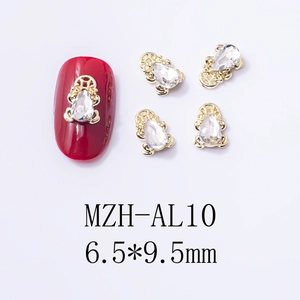 Macro detail of golden bear nail charms with crystal zircon and MZH-AL10 size marking