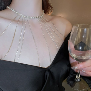 Close-up of sparkling rhinestone body chain featuring a draped tassel shoulder design