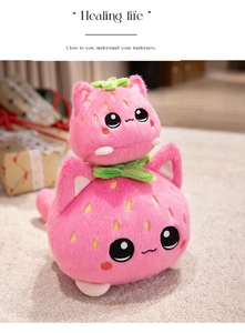 Detail of plush strawberry cat toys with pink fur and embroidered seed textures