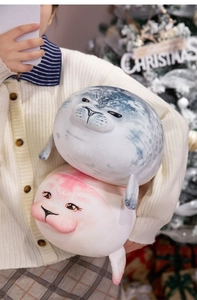 Close-up of soft seal plush toys in grey and pink colors for Christmas gift