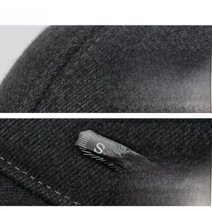 Detailed macro view of dark grey winter hat featuring Sport label and thick knit texture