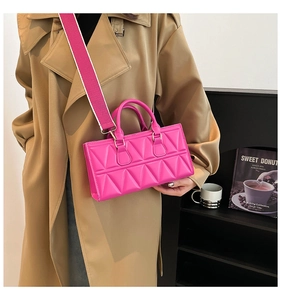 Detail of pink PU leather square bag featuring 3D geometric quilted triangle patterns