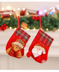 Close-up of small Christmas stockings with 3D Santa and Bear dolls on a tree