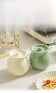 Detail of high-capacity ceramic seasoning pots with lids and spoons for modern kitchens