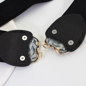 Elastic black waist belt with golden heart interlocking buckle and faux leather detail